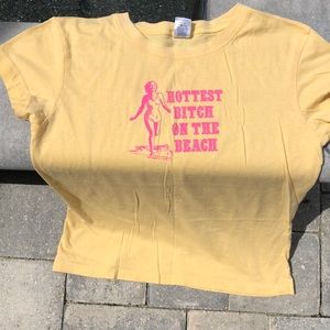 Cute yellow and pink T shirt! Does have bad word!